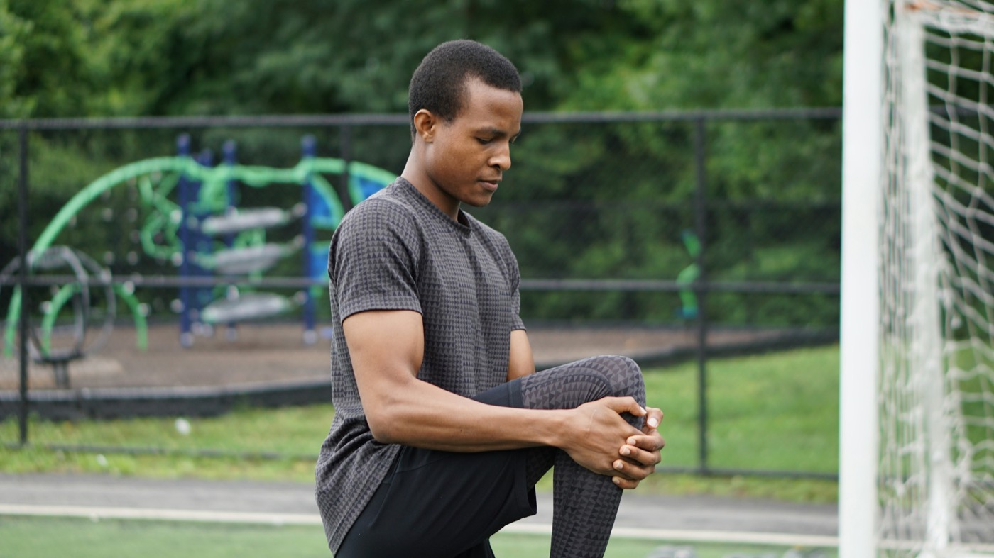 A man stretching outdoors before exercise